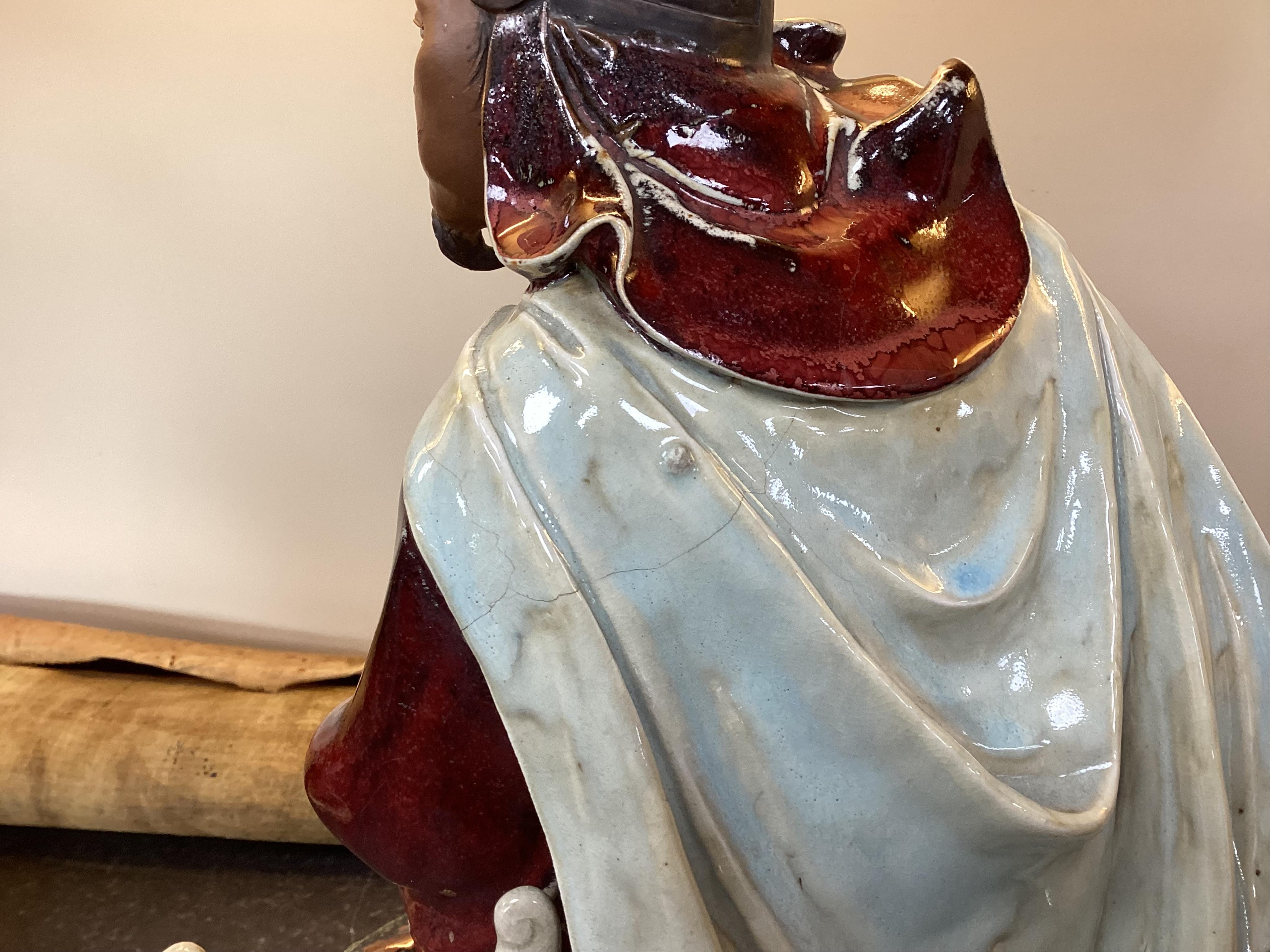 A large Chinese Shiwan stoneware figure of a warrior, 20th century